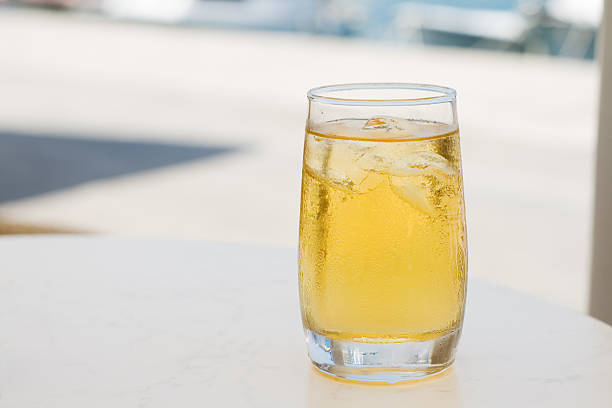 Glass of apple juice with ice on a restaurants table